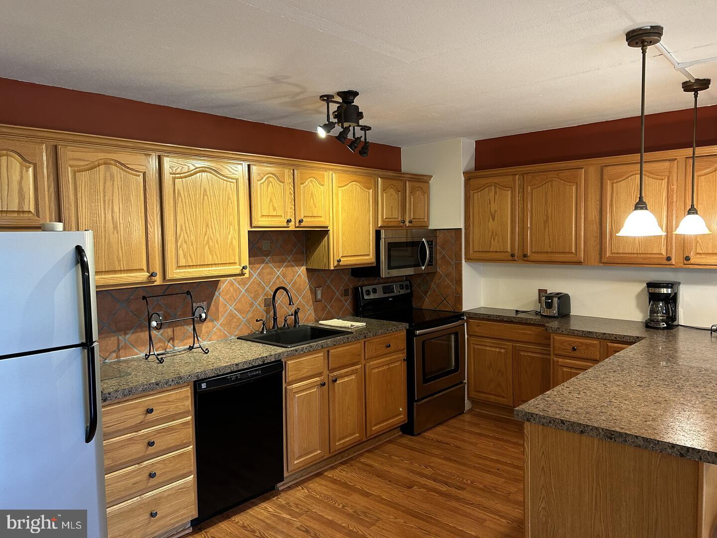 68 Welsh Tract Road, Unit D106 Newark, DE 19713 - Photo 2 of 10 a kitchen with a sink stove and refrigerator