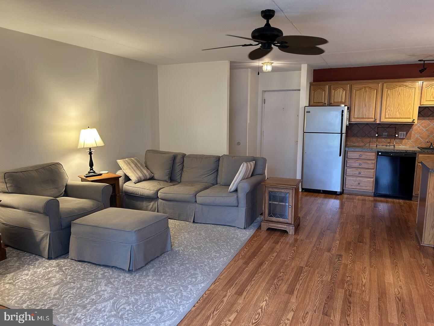 68 Welsh Tract Road, Unit D106 Newark, DE 19713 - Photo 5 of 10 a living room with furniture and a wooden floor