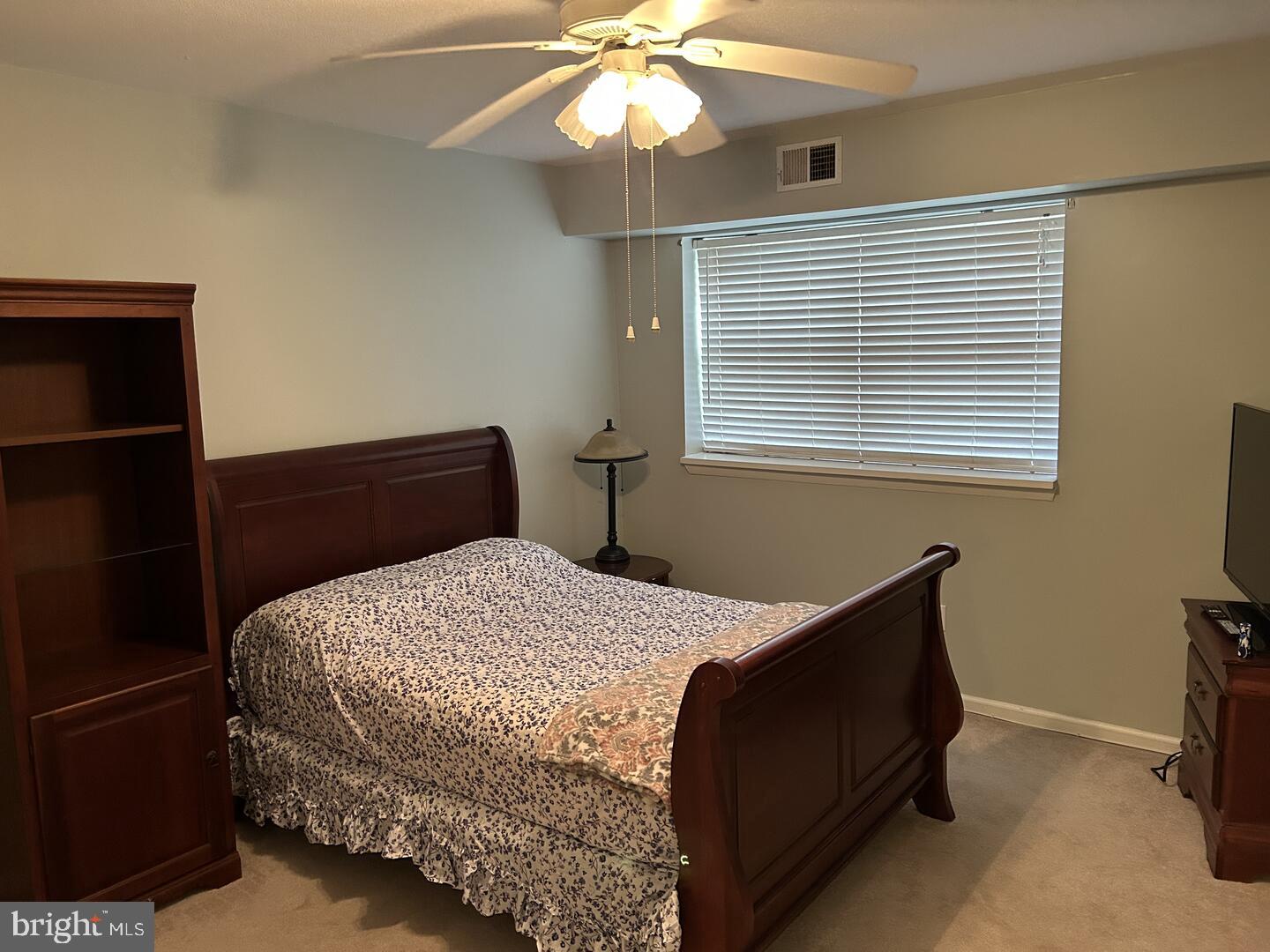 68 Welsh Tract Road, Unit D106 Newark, DE 19713 - Photo 6 of 10 a bedroom with a bed and a chandelier