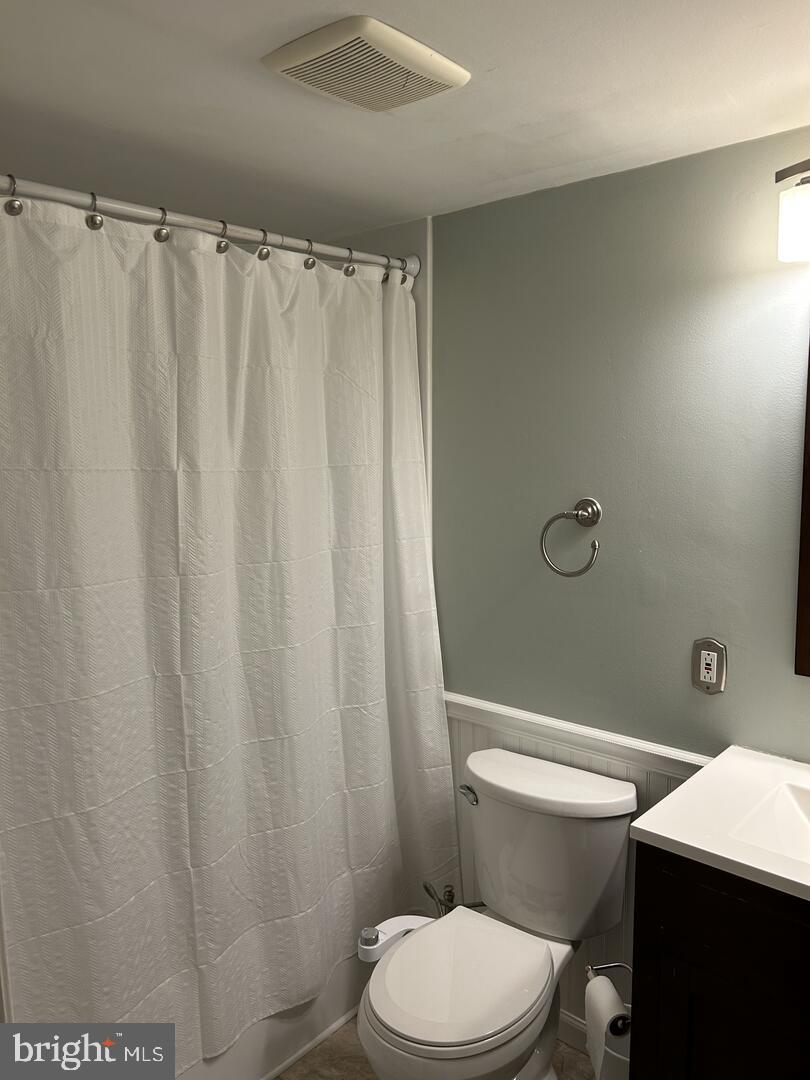 68 Welsh Tract Road, Unit D106 Newark, DE 19713 - Photo 8 of 10 a white toilet sitting next to a shower curtain