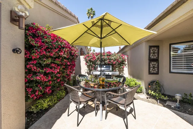 a view of a house with backyard sitting area and swimming pool