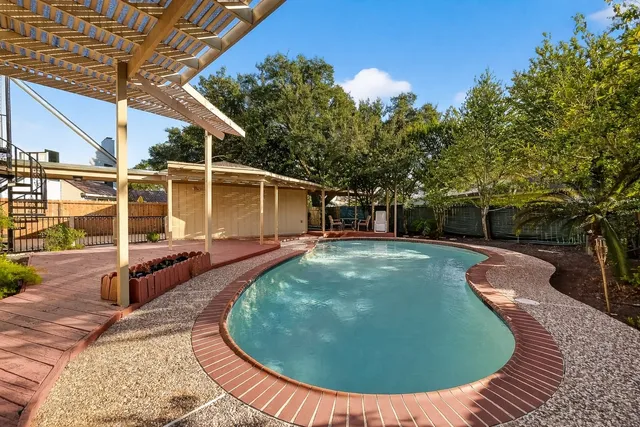 a view of a swimming pool with a patio