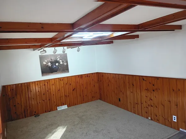 a view of a room with wooden walls