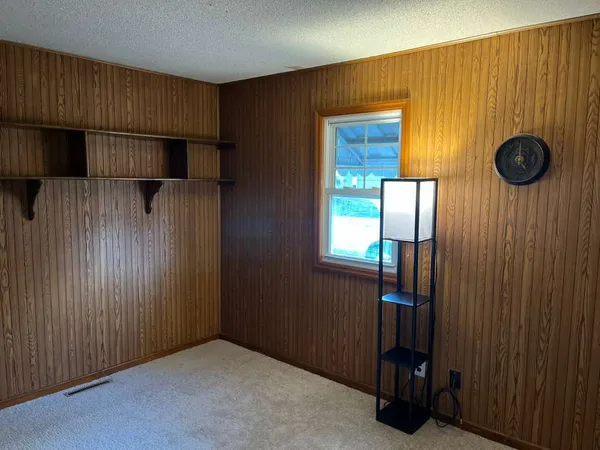 a view of a livingroom with entryway & cabinets