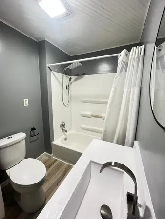a bathroom with a toilet and a tub