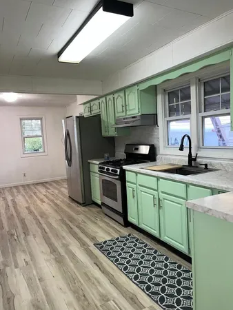 a kitchen with a sink and a stove top oven
