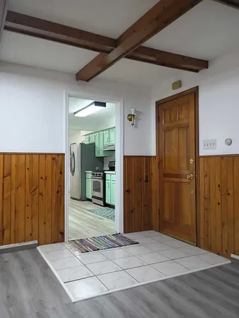a view of a hallway with wooden walls