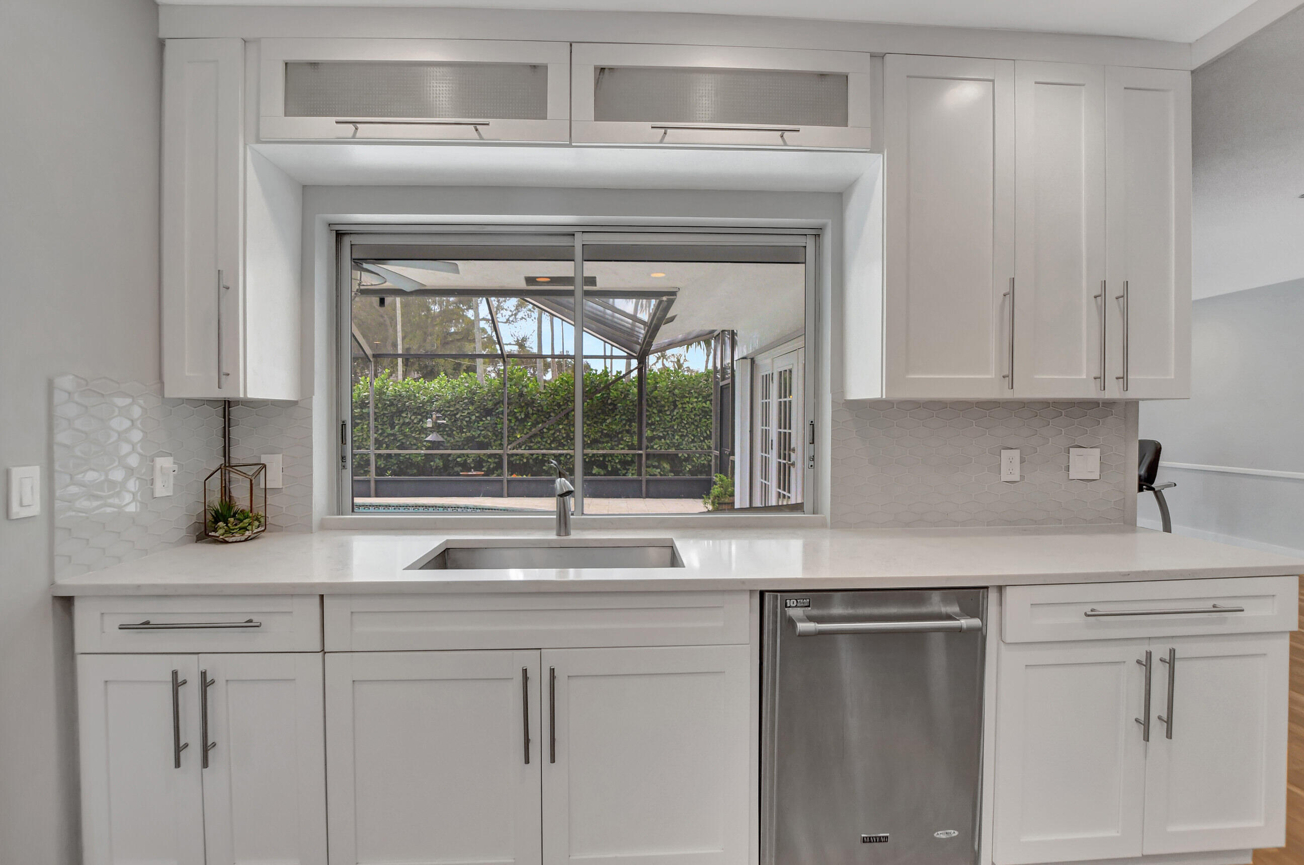 510 Silver Lane Boca Raton, FL 33432 - Photo 6 of 24 a kitchen with white cabinets and a sink