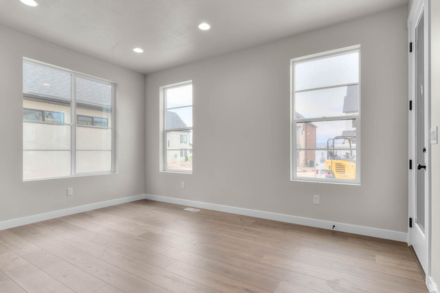 1567 North 3250 West Provo, UT 84601 - Photo 10 of 22 Spacious room featuring wood-finish flooring, recessed lighting, and multiple windows