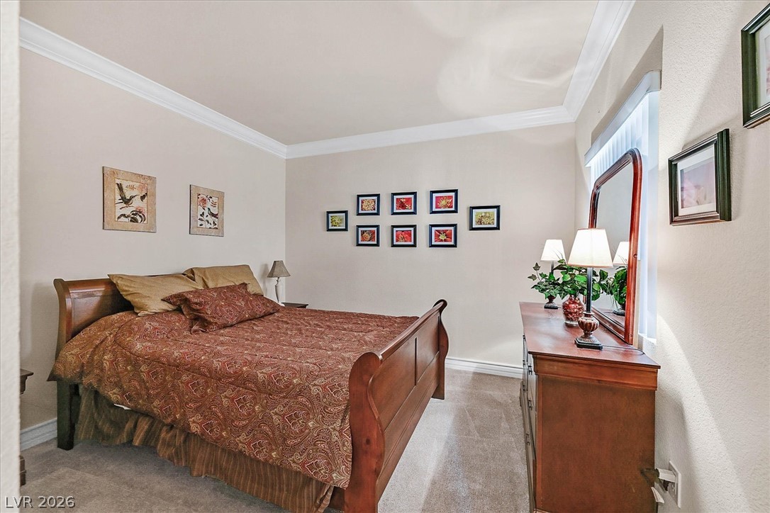 220 East Flamingo Road, Unit 305 Las Vegas, NV 89169 - Photo 12 of 26 Tasteful crown molding enhances this comfortable bedroom with plush carpeting.