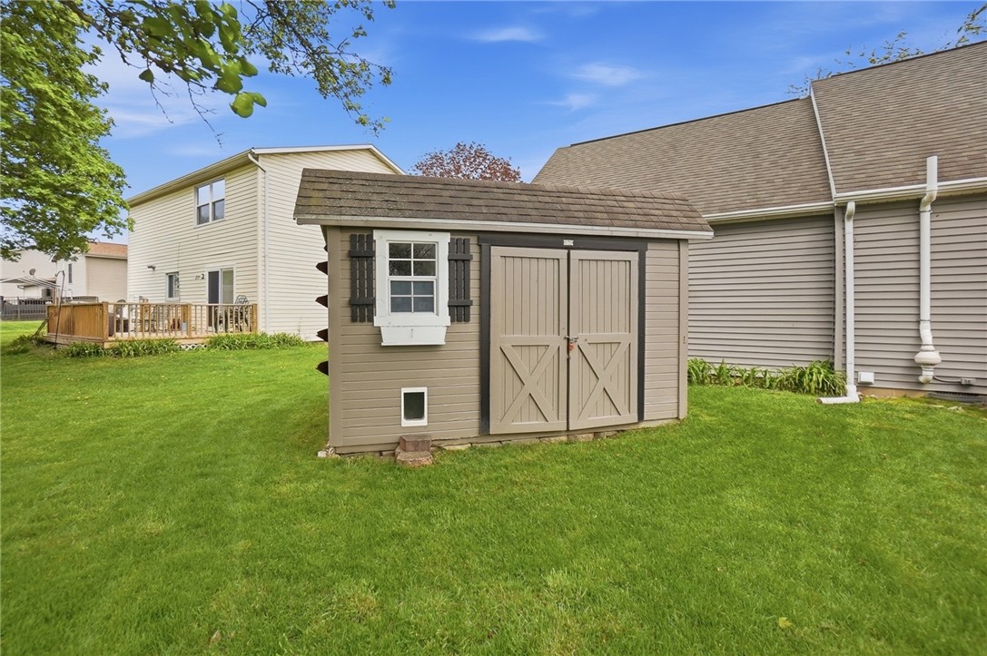 135 Concord Farm Road Englewood, OH 45322 - Photo 46 of 46 This spacious backyard features a well-maintained lawn, a practical storage shed, and an expansive wooden deck.