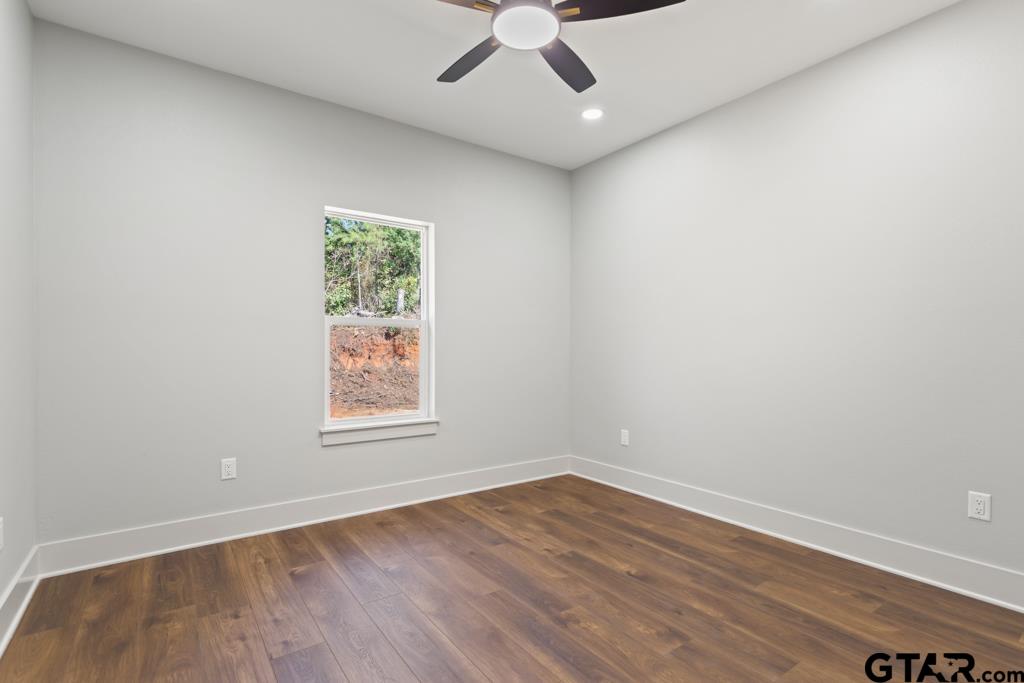 15837 Stillwaters Lindale, TX 75771 - Photo 27 of 32 an empty room with a window and wooden floor
