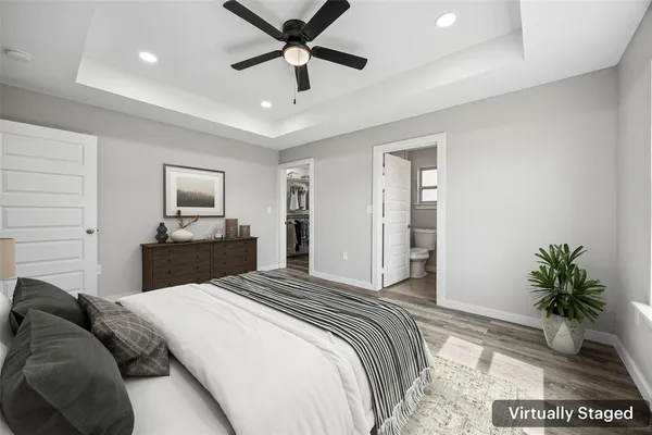 a bedroom with a large bed and a chandelier