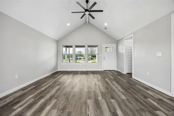 wooden floor in an empty room with a window
