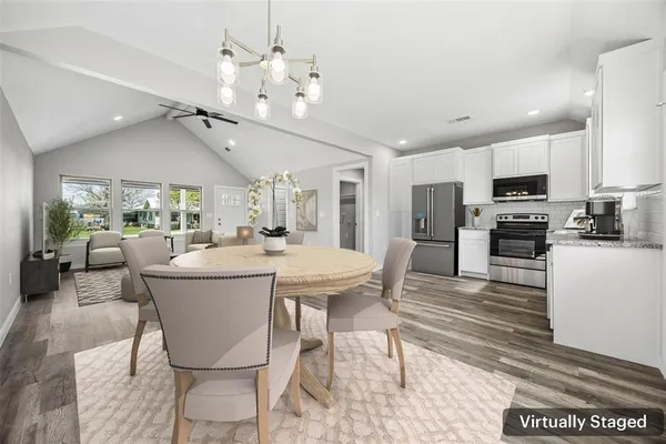 a living room with stainless steel appliances kitchen island granite countertop furniture and a kitchen view