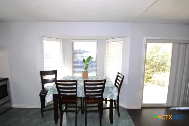 a view of a dining room with furniture and window