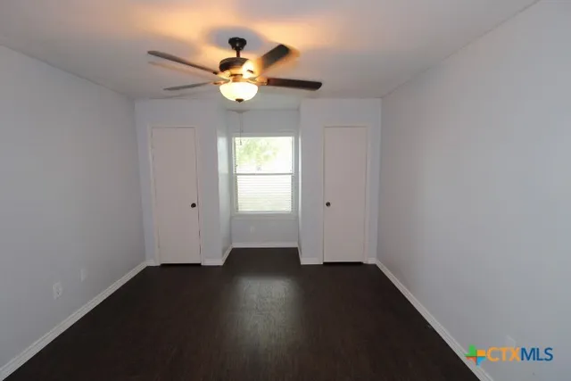 a view of wooden floor and a chandelier in a room
