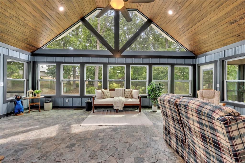 399 Smith Road Ball Ground, GA 30107 - Photo 13 of 63 a living room with furniture and large windows