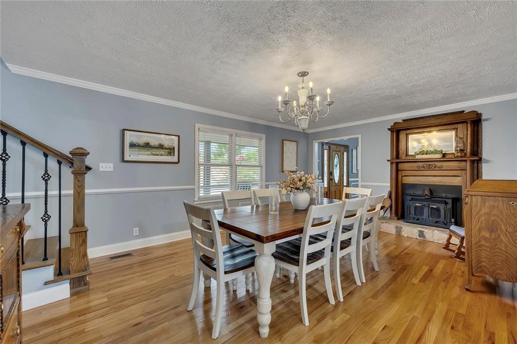 399 Smith Road Ball Ground, GA 30107 - Photo 15 of 63 a view of a dining room with furniture window and wooden floor