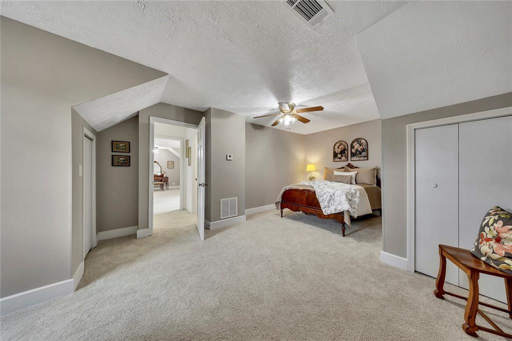 399 Smith Road Ball Ground, GA 30107 - Photo 35 of 63 a bed room with a bed and a ceiling fan