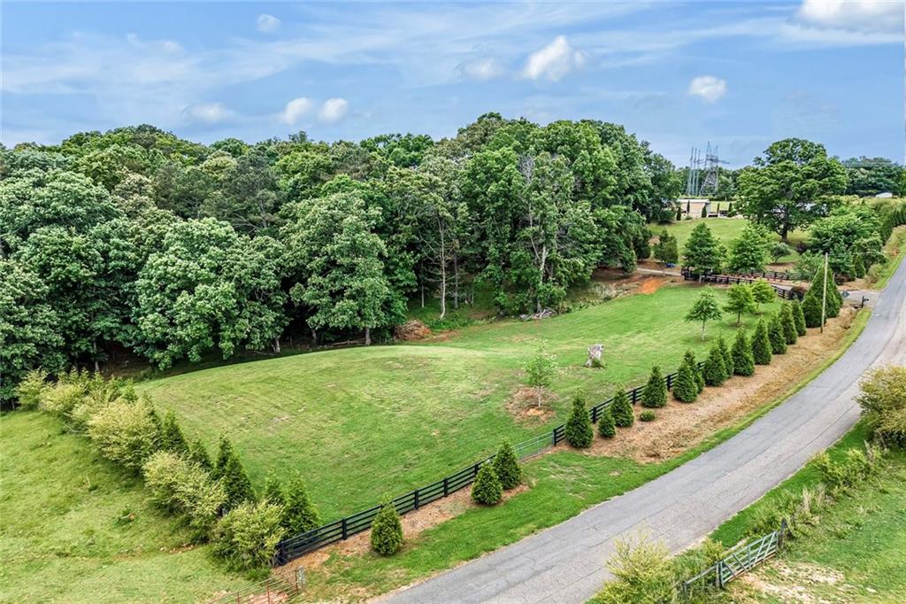 399 Smith Road Ball Ground, GA 30107 - Photo 60 of 63 a view of a garden with a building in the background