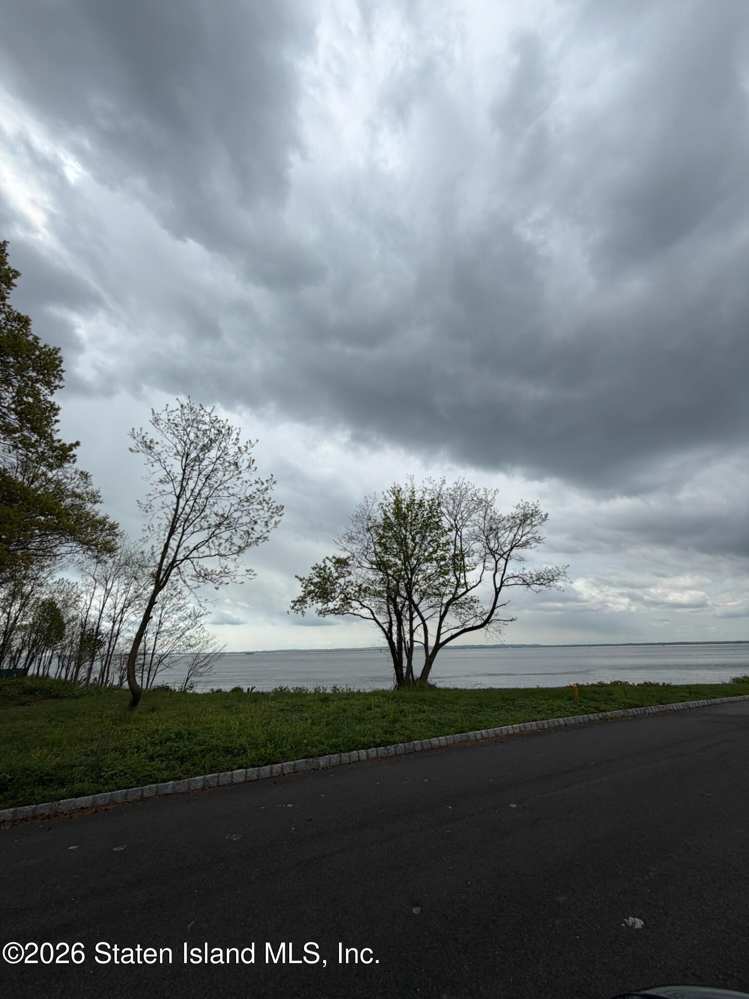 74 Discala Lane Staten Island, NY 10312 - Photo 3 of 3 a view of a lake from a yard