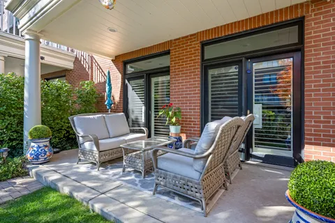 a view of a patio with table and chairs and potted plants
