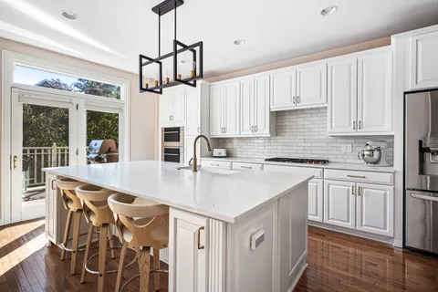 a kitchen with stainless steel appliances granite countertop a sink and cabinets