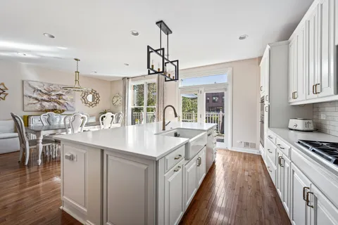 a kitchen with sink stove and wooden floor