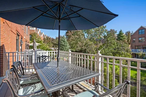 a view of balcony with furniture and umbrella