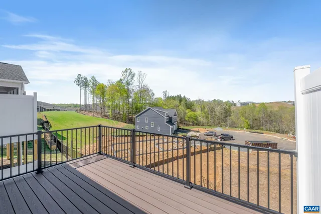 a view of a balcony with wooden floor & fence