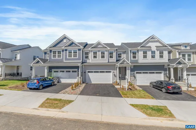 a car parked in front of a white house