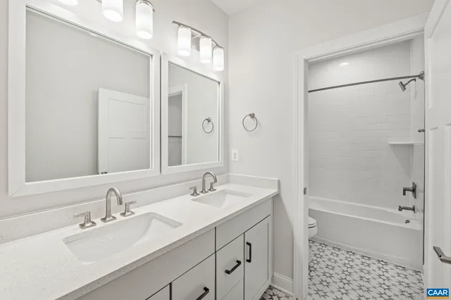 a bathroom with a bathtub shower sink vanity and a mirror