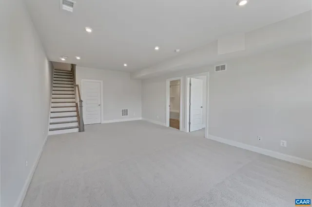 a view of an empty room with stairs