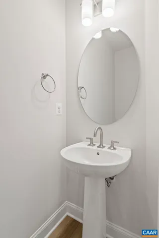 a bathroom with a sink a mirror and shower