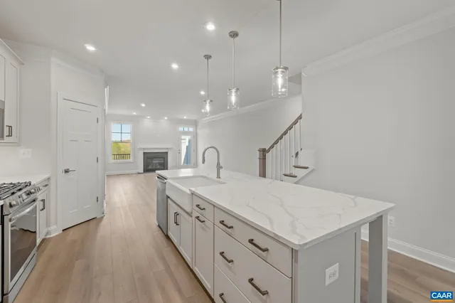 a kitchen with sink stove and refrigerator