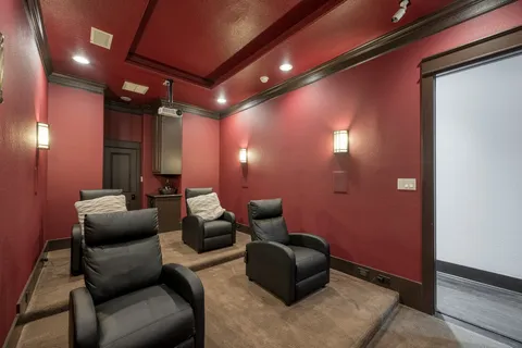 a media room with lots of chairs and a projector screen