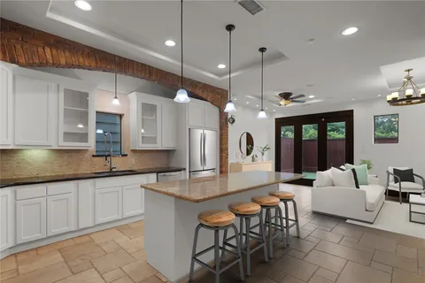 a large kitchen with a table and chairs