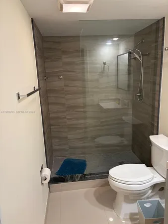 a bathroom with a toilet and a shower