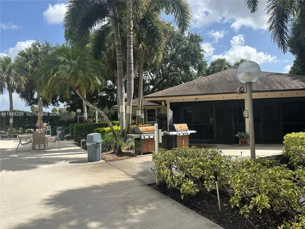 a front view of a house with yard and green space
