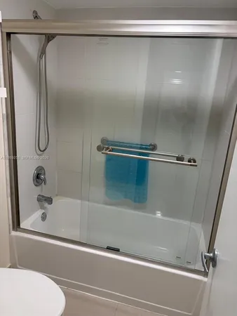 a bathroom with a shower and a bath tub