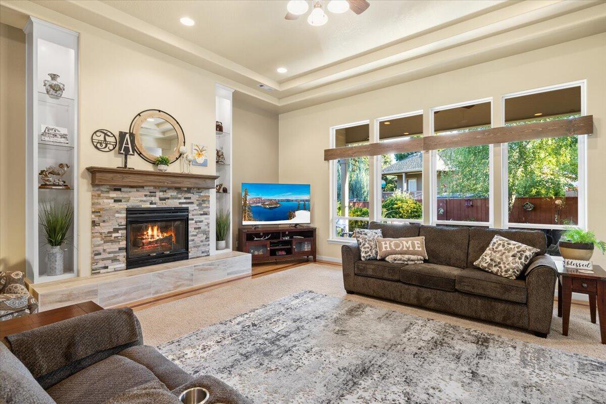 1105 Pumpkin Ridge Eagle Point, OR 97524 - Photo 9 of 40 a living room with furniture a large window and a fireplace
