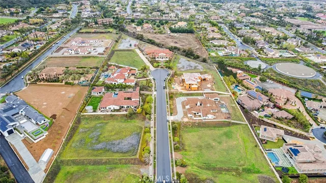 an aerial view of residential houses with yard