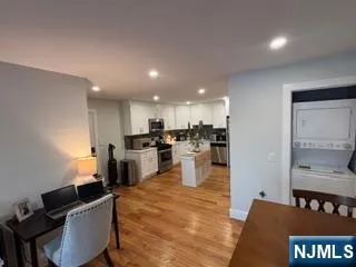 a living room with stainless steel appliances kitchen island granite countertop furniture and a view of kitchen