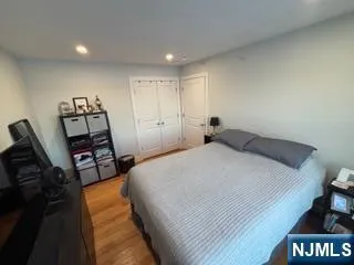 a bedroom with a bed and a view of kitchen