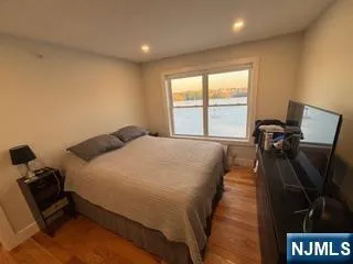 a bed sitting in a room next to a window