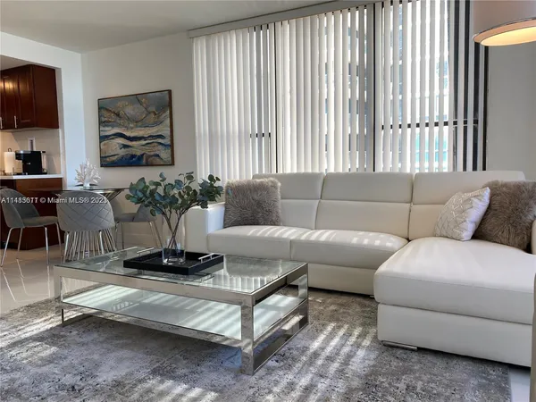 a living room with furniture and a potted plant