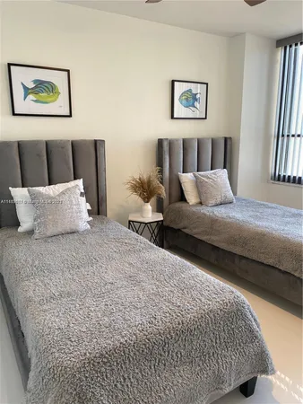 a bedroom with bed and wall painting