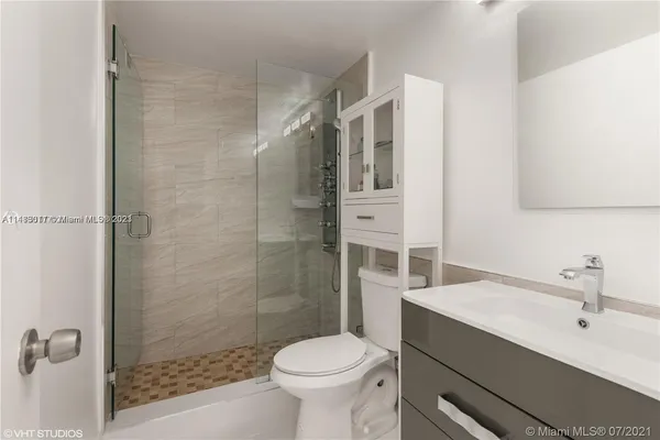 a bathroom with a sink toilet and shower
