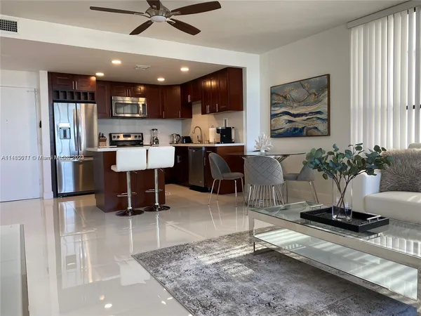 a living room with furniture a window and kitchen view